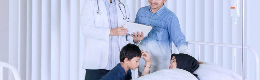A gynaecologist and family visiting a female patient.